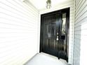 Stylish black front door with sidelight and modern exterior lighting at 9513 Isaac Hunter Dr, Charlotte, NC 28214
