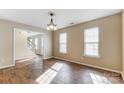 Bright dining room with hardwood floors and elegant chandelier, bathed in natural light at 9900 Meadowmead Ct, Charlotte, NC 28273