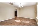 Light-filled living room with stylish chandelier and hardwood floors, creating an inviting space at 9900 Meadowmead Ct, Charlotte, NC 28273