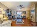 Bright living room with hardwood floors, ceiling fan, and stylish decor at 1049 Ramsey St, Stanley, NC 28164