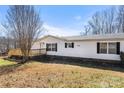Wide view of the home's vinyl siding and black shutters on a clear day at 109 Fish Hill Dr, Statesville, NC 28677