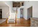 Bright foyer features a staircase with wooden banister and iron spindles, leading to the second floor at 1116 Crooked River Dr, Waxhaw, NC 28173