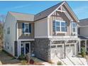 Charming two-story home features a two-car garage, stone accents, and a welcoming entrance at 1232 Scotch Meadows Loop, Monroe, NC 28110