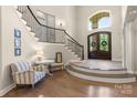 Grand foyer with a striking staircase, wood floors, and an abundance of natural light at 133 Crooked Branch Way, Troutman, NC 28166