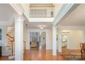 Grand foyer with hardwood floors, soaring ceilings, and elegant architectural columns at 140 Melbourne Dr, Fort Mill, SC 29708