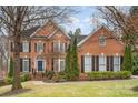 Stately brick home featuring black shutters, arched windows, and a manicured front yard at 140 Melbourne Dr, Fort Mill, SC 29708