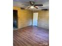 Living room with wood look flooring, ceiling fan and white door at 1612 Carter Rd, Lancaster, SC 29720