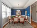 Formal dining room featuring blue accent wall, decorative chandelier, and large window at 1796 Williamsburg Dr, Rock Hill, SC 29732