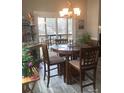 Inviting dining area features a round wooden table and chairs with views to the deck at 194 Hattaway Cir, Mount Gilead, NC 27306