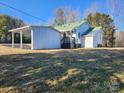 Side view of a home with a detached carport and shed, set on a grassy lot at 200 Hillcrest Ave, Hickory, NC 28601