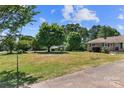 Expansive front yard leading to a charming home, creating a welcoming approach at 208 Caleb Rd, Shelby, NC 28152