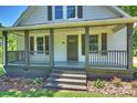 Inviting covered front porch with decorative columns, wood railings, and a charming entrance at 237 Mcneely Ave, Mooresville, NC 28115