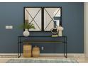 Staged entryway with a console table, decorative mirrors, baskets, vases, and a rug at 2811 Morning Song Way, Lancaster, SC 29720