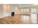 Bright and airy living room with luxury vinyl plank flooring, a fireplace, and built-in cabinets at 2811 Morning Song Way, Lancaster, SC 29720