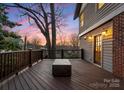Spacious wooden deck with railing and a modern fire pit, perfect for outdoor entertaining at 2924 Chelsea Dr, Charlotte, NC 28209
