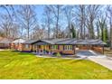 Charming brick home featuring a well-manicured lawn and convenient carport at 308 Dakota St, Kannapolis, NC 28083