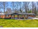 Charming brick home featuring a well-manicured lawn and convenient carport at 308 Dakota St, Kannapolis, NC 28083