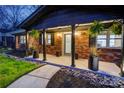 Inviting front porch with stylish planters, decorative rock landscaping, and welcoming entry at 308 Dakota St, Kannapolis, NC 28083