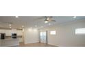 Bright living room open to kitchen with hardwood floors, recessed lighting, and lots of natural light at 3207 Lisburn St, Charlotte, NC 28227
