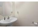 Clean half bath with white pedestal sink and a mirror at 3627 Alexander Forest Dr, Charlotte, NC 28269