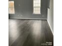 Spacious living room features neutral paint, large windows and hardwood flooring for a welcoming atmosphere at 4226 Red Shed Ln, Charlotte, NC 28269