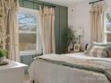 Bright bedroom offering a comfortable space and serene view from the large windows at 5622 S Rocky River Rd, Monroe, NC 28112