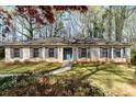 Charming one-story home featuring a brick facade, blue shutters, a well-manicured lawn, and a welcoming blue front door at 800 River Oaks Ln, Charlotte, NC 28226