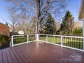 Spacious backyard deck with railing, perfect for outdoor entertaining and enjoying nature at 9921 Ridgemore Dr, Charlotte, NC 28277
