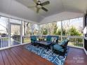 Relaxing screened-in porch with comfortable seating, ceiling fan, and view of lush backyard at 9921 Ridgemore Dr, Charlotte, NC 28277