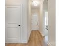 Bright entryway featuring wood-look flooring, white walls, and views into other rooms in the house at 1113 Idyllic Ln, Waxhaw, NC 28173