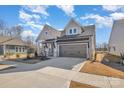 New construction with gray siding, a two-car garage, and a driveway that provides ample parking at 1113 Idyllic Ln, Waxhaw, NC 28173