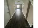 Inviting hallway with dark wood-look floors leading to a bright, open living space at 14331 Evening Flight Ln, Charlotte, NC 28262