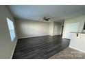 Spacious living room with neutral walls, modern ceiling fan, and bright natural light at 14331 Evening Flight Ln, Charlotte, NC 28262