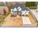 Stunning overhead view of a stucco home with a dark roof, spacious lawn, and charming curb appeal at 15818 Sparrowridge Ct, Charlotte, NC 28278