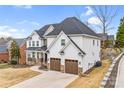 Attractive stucco house featuring a dark roof, an attached two-car garage, and well-maintained landscaping at 15818 Sparrowridge Ct, Charlotte, NC 28278