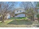 A view of the backyard with a metal carport and small storage shed at 1607 Harrill St, Charlotte, NC 28205