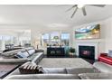 Cozy living room features a fireplace, large windows, and comfortable seating at 16617 Cozy Cove Rd, Charlotte, NC 28278