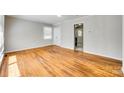 Bright living room featuring hardwood floors, neutral paint, and an open doorway to the entryway at 2123 Purser Dr, Charlotte, NC 28215
