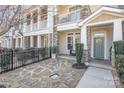 A charming entryway with a stone paver patio and walkway leads to the front door at 234 Iverson Way, Charlotte, NC 28203