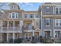 Charming townhome with a combination of stone and siding and a lovely fenced front yard at 234 Iverson Way, Charlotte, NC 28203