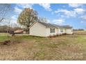 Side view of a well-maintained home, showcasing lush backyard greenery and ample outdoor space at 24697 Ramsey Dr, Albemarle, NC 28001
