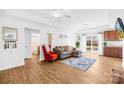 Open-concept living space featuring a bathroom and an adjoining kitchen, hardwood floors, and abundant natural light at 2625 Larry Dr, Charlotte, NC 28214