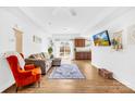 Inviting living area featuring hardwood floors, a comfortable couch, a flat screen TV, and sliding glass doors at 2625 Larry Dr, Charlotte, NC 28214