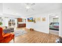 Bright living room with wood floors, neutral decor, and seamless flow into the kitchen and bedroom at 2625 Larry Dr, Charlotte, NC 28214