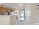 Bright kitchen features ample cabinet space, a breakfast bar, and an open entryway at 331 Wilkes Place Dr, Fort Mill, SC 29715