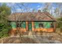 Charming exterior of a two-story home with a brick foundation and green trim around the windows and a green front door at 335 Summit Se Ct, Concord, NC 28025