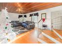 Bright living room boasts wood floors, a wooden ceiling, neutral walls, and a staircase with metal railing at 335 Summit Se Ct, Concord, NC 28025