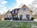 Well-maintained brick home with classic shutters, manicured bushes and lawn, and a charming front entrance at 4130 Waterway Dr, Monroe, NC 28110