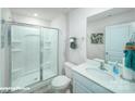 Well-lit bathroom featuring a glass-enclosed shower and a modern vanity at 8043 Plymouth Rd, Sherrills Ford, NC 28673