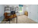 Bright office space with a large window, shelving and a wooden desk at 8043 Plymouth Rd, Sherrills Ford, NC 28673